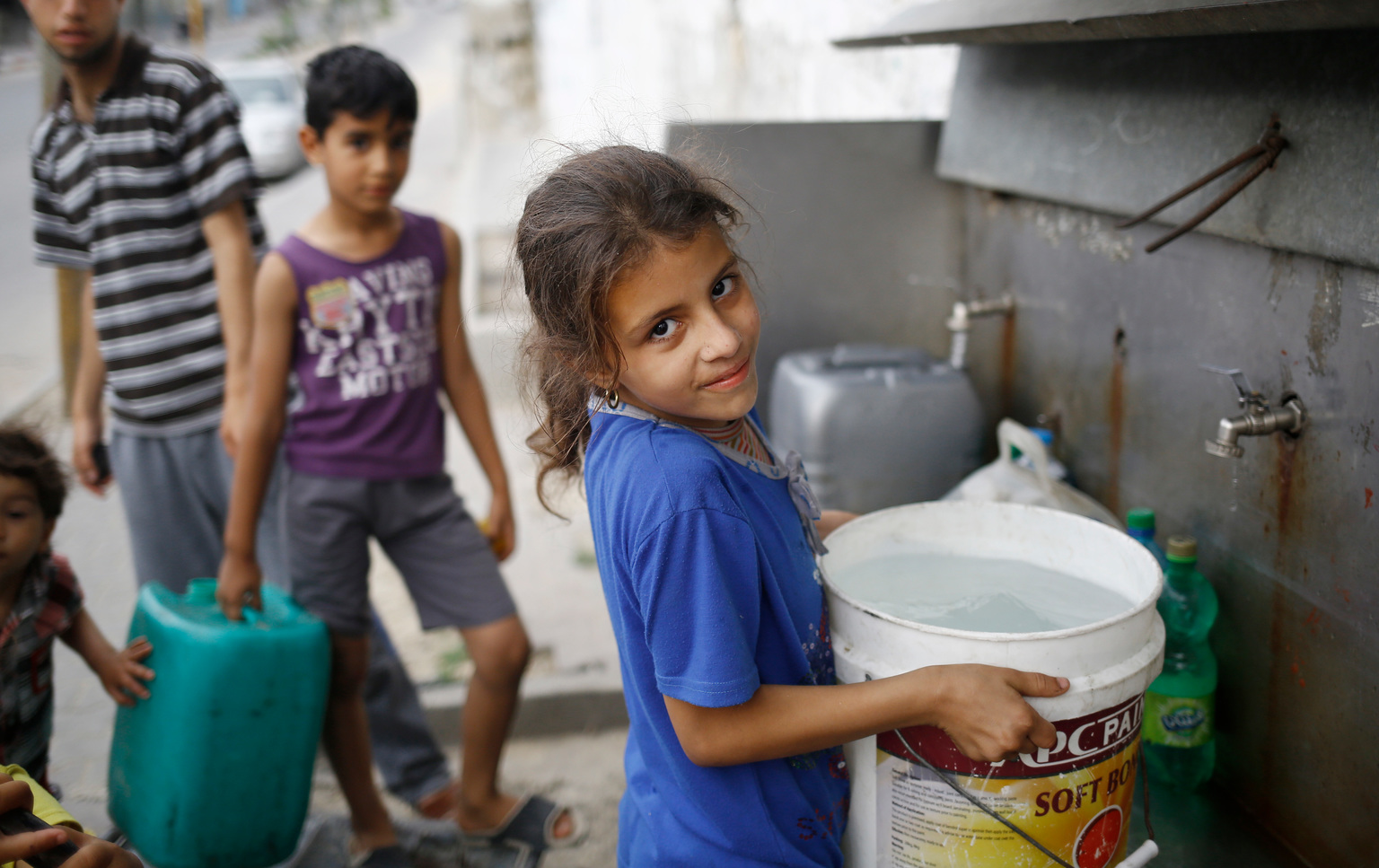 Girl getting water, Gaza.