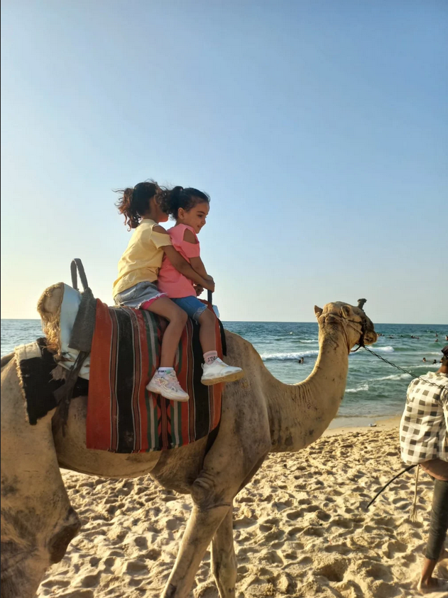 Children on camel, Gaza, 2023.