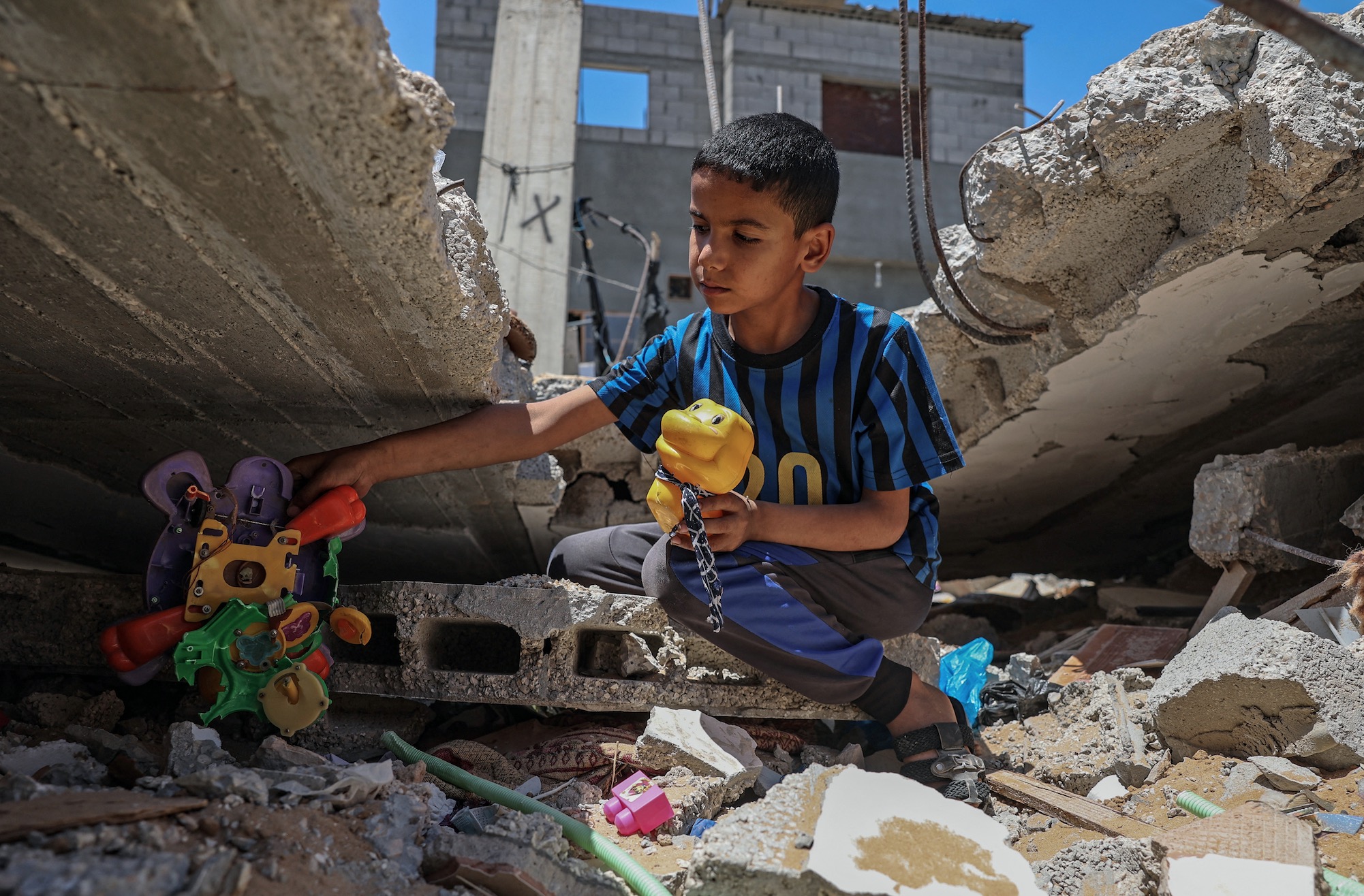 Boy in Gaza playing with toys.